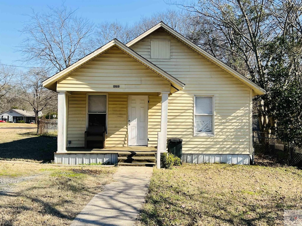 bungalow-style house with a front lawn