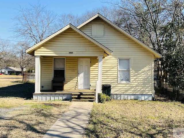 bungalow-style house with a front lawn