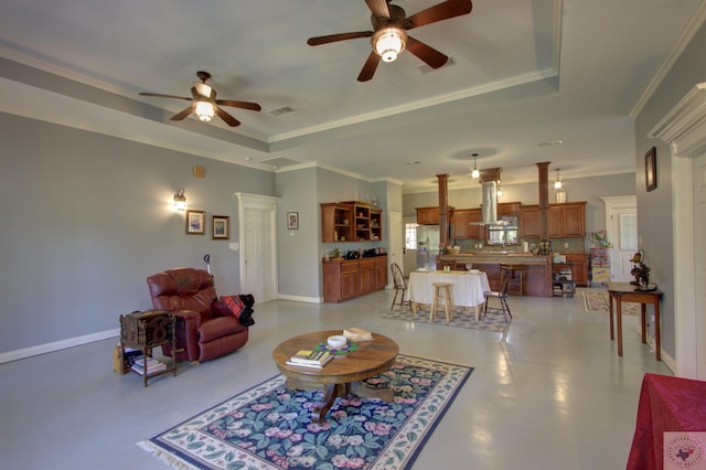 living room featuring crown molding and a raised ceiling