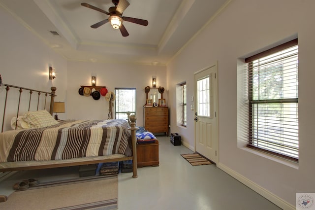 bedroom with ceiling fan, crown molding, multiple windows, and a tray ceiling