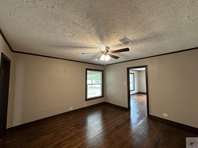 empty room with ceiling fan, a textured ceiling, dark hardwood / wood-style floors, and ornamental molding