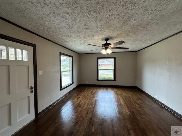 entryway with a textured ceiling, dark hardwood / wood-style floors, ceiling fan, and ornamental molding