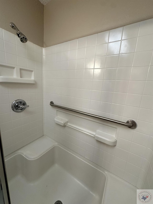 bathroom with tiled shower