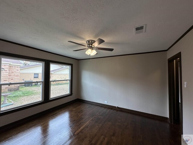 unfurnished room featuring ceiling fan, a textured ceiling, dark hardwood / wood-style floors, and ornamental molding