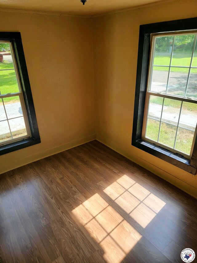 501 S Columbia St, Clarksville, TX 75426 - spare room featuring dark wood finished floors