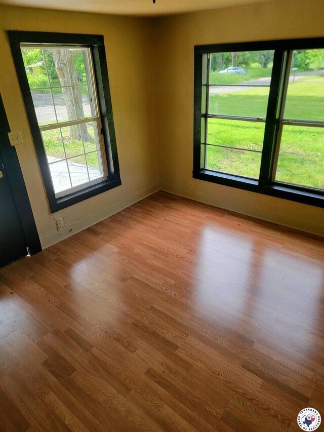 501 S Columbia St, Clarksville, TX 75426 - unfurnished room with healthy amount of natural light and wood finished floors