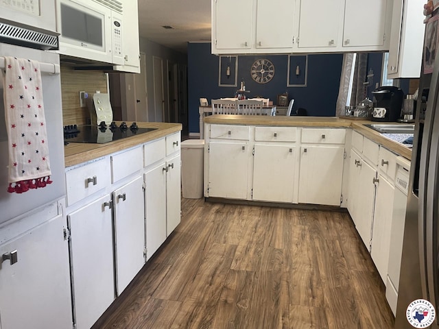 1921 E 40th St, Texarkana, AR 71854 - kitchen featuring white appliances, light countertops, dark wood-type flooring, white cabinetry, and backsplash