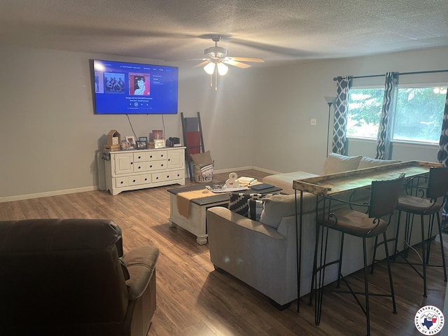1921 E 40th St, Texarkana, AR 71854 - living room with wood finished floors, a textured ceiling, and ceiling fan