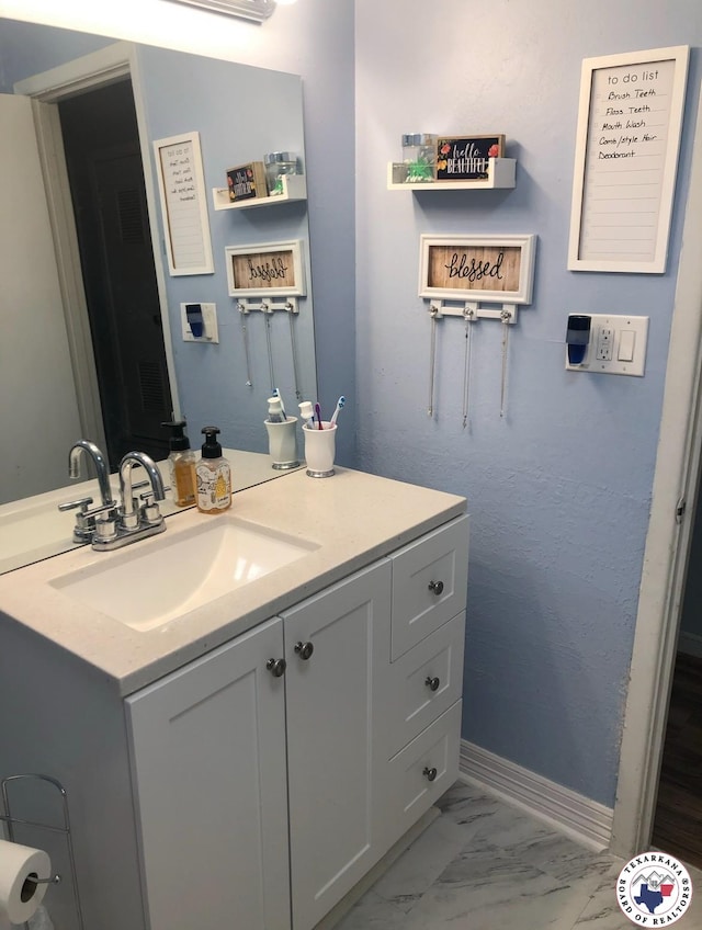 1921 E 40th St, Texarkana, AR 71854 - bathroom featuring marble finish floors and vanity