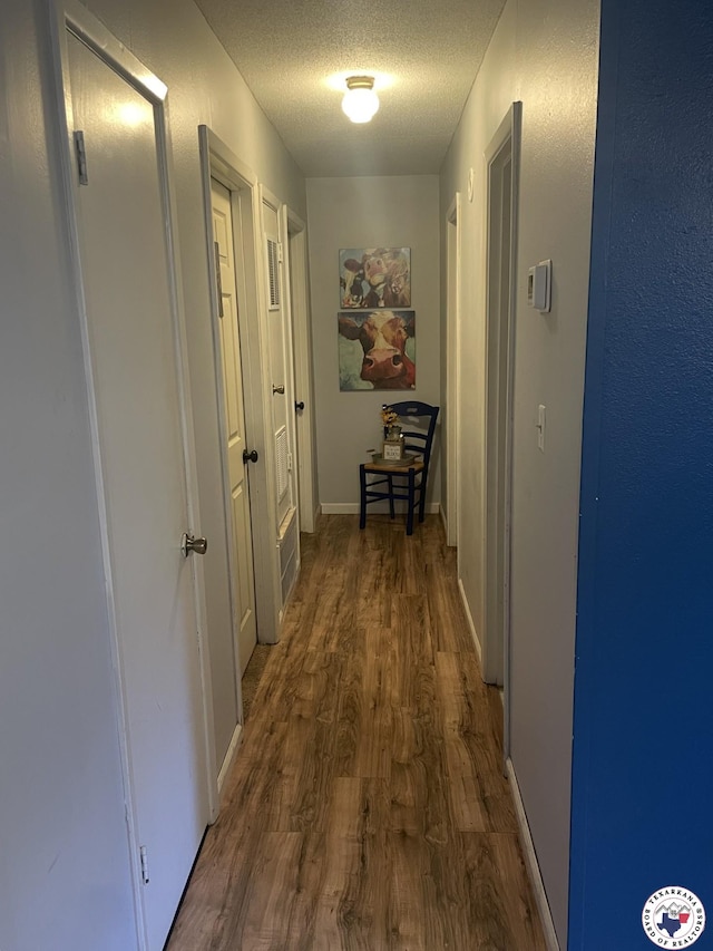 1921 E 40th St, Texarkana, AR 71854 - hall with wood finished floors and a textured ceiling