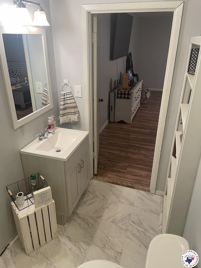 1921 E 40th St, Texarkana, AR 71854 - bathroom featuring marble look tile flooring and vanity