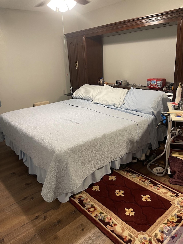 bedroom with ceiling fan and hardwood / wood-style floors