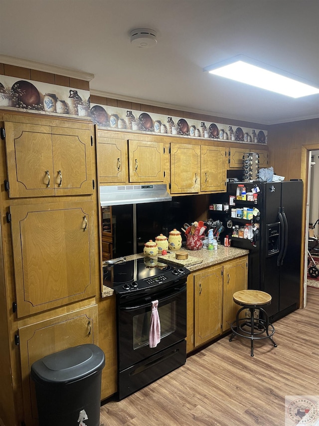 kitchen featuring black appliances and light hardwood / wood-style floors