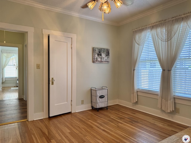2504 Walnut St, Texarkana, TX 75503 - unfurnished bedroom featuring light wood-type flooring and crown molding