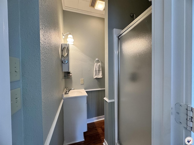 2504 Walnut St, Texarkana, TX 75503 - full bathroom featuring a shower stall, vanity, wood finished floors, and a textured wall