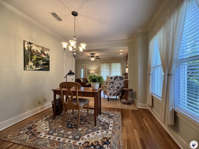 2504 Walnut St, Texarkana, TX 75503 - dining area with a chandelier, dark wood-style flooring, a textured ceiling, crown molding, and a ceiling fan