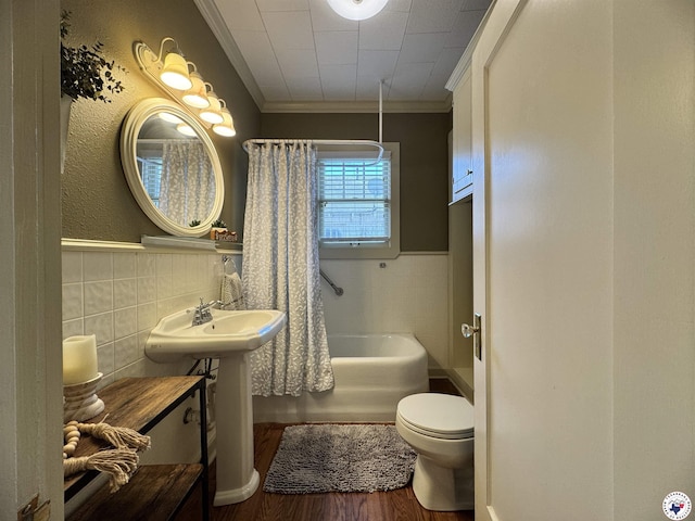 2504 Walnut St, Texarkana, TX 75503 - full bath featuring tile walls, crown molding, wood finished floors, wainscoting, and shower / bath combo with shower curtain