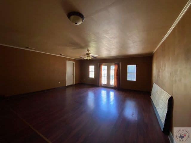 unfurnished room with ceiling fan, french doors, crown molding, and dark hardwood / wood-style flooring