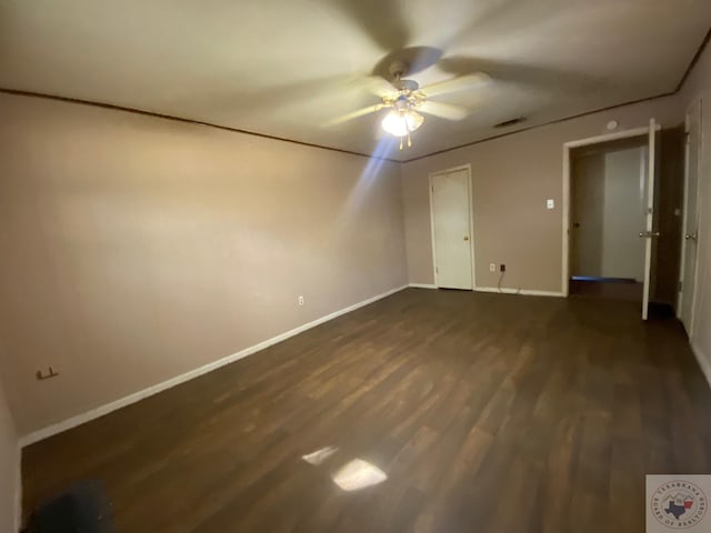 unfurnished bedroom featuring ceiling fan and dark hardwood / wood-style flooring