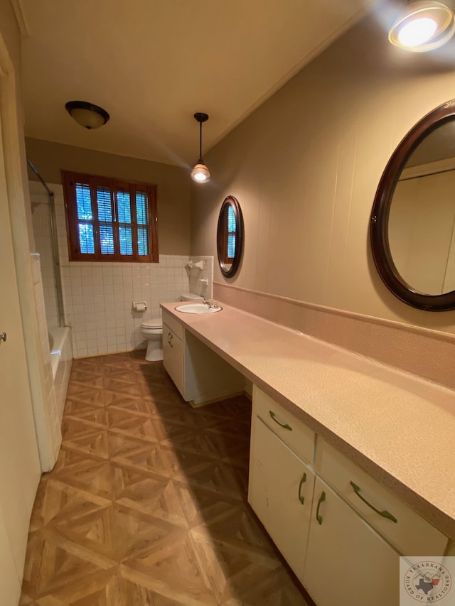 full bathroom featuring tile walls, toilet, vanity, parquet flooring, and shower / bathing tub combination