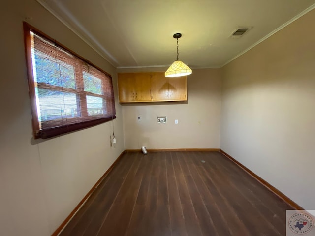 laundry area with crown molding and dark wood-type flooring