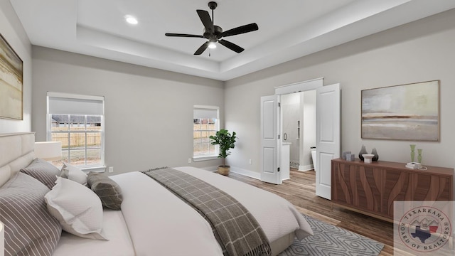 bedroom featuring ceiling fan, a raised ceiling, and dark hardwood / wood-style floors