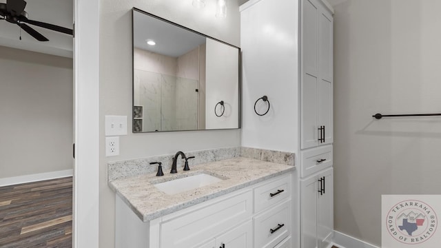 bathroom featuring vanity, ceiling fan, a shower, and wood-type flooring