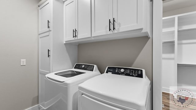 washroom featuring cabinets and washer and dryer