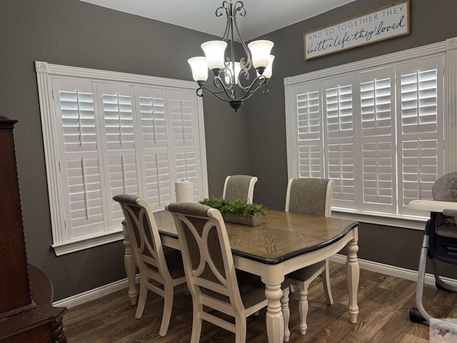 dining space with a chandelier and dark hardwood / wood-style floors