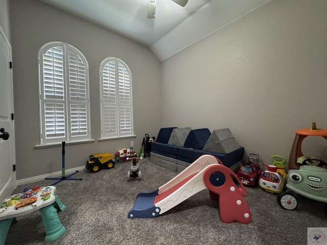 recreation room with vaulted ceiling, ceiling fan, and carpet floors