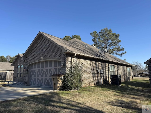 view of property exterior featuring a garage, central AC unit, and a lawn