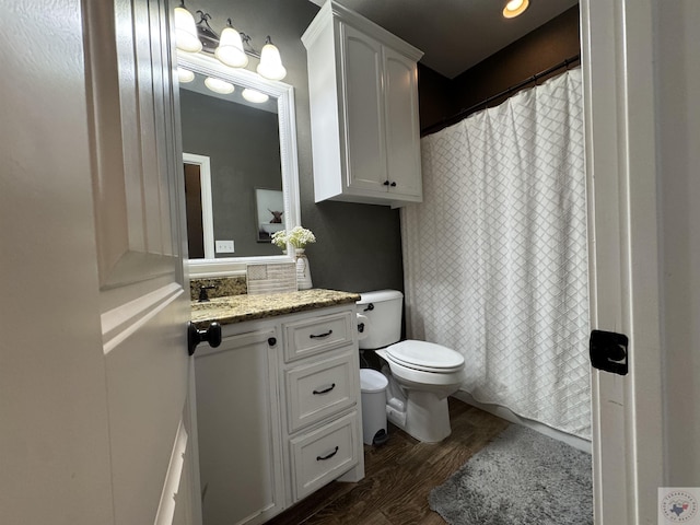 bathroom with wood-type flooring, toilet, and vanity