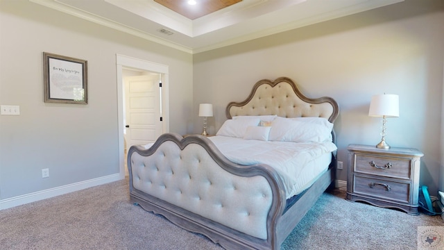 bedroom with crown molding, carpet, and a raised ceiling