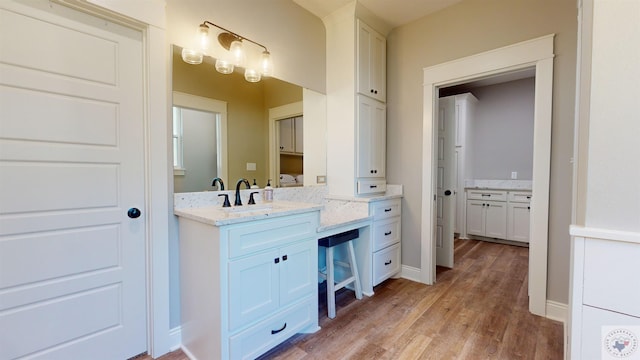 bathroom featuring hardwood / wood-style flooring and vanity