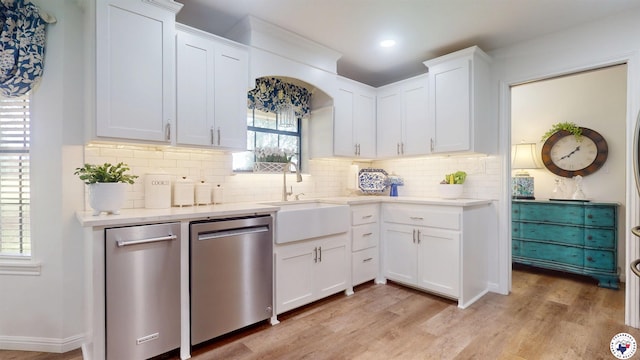 144 Joe Tyl Rd, Texarkana, TX 75501 - kitchen with stainless steel dishwasher, light countertops, decorative backsplash, white cabinetry, and recessed lighting