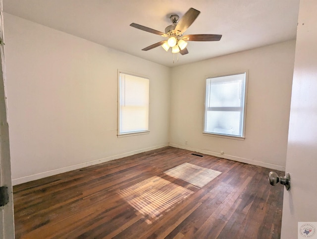 unfurnished room featuring ceiling fan and dark wood-type flooring