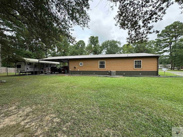 75 Westwood Ln, New Boston, TX 75570 - back of property featuring a carport, cooling unit, and a lawn