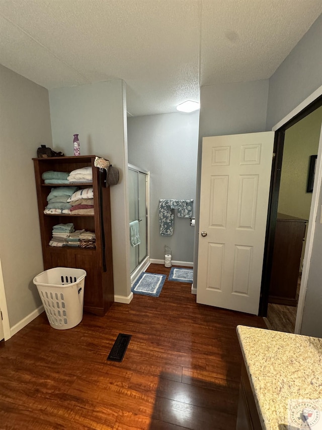 75 Westwood Ln, New Boston, TX 75570 - bathroom featuring hardwood / wood-style flooring, vanity, a textured ceiling, and walk in shower