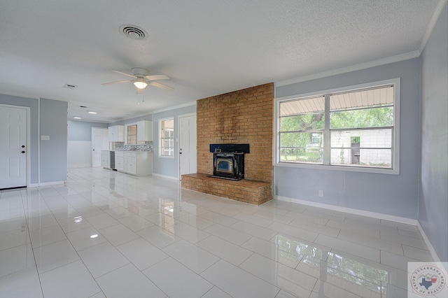 unfurnished living room featuring crown molding, a textured ceiling, light tile patterned floors, and ceiling fan