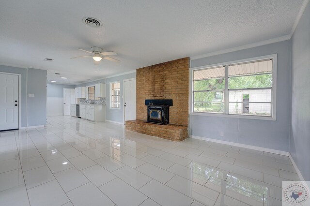 unfurnished living room featuring crown molding, a textured ceiling, light tile patterned floors, and ceiling fan