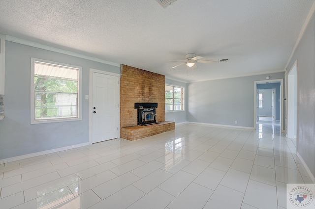 unfurnished living room with a textured ceiling, light tile patterned floors, ceiling fan, and ornamental molding