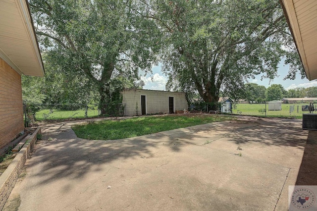 view of patio featuring an outbuilding