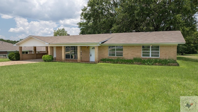 ranch-style home featuring a front yard and a carport