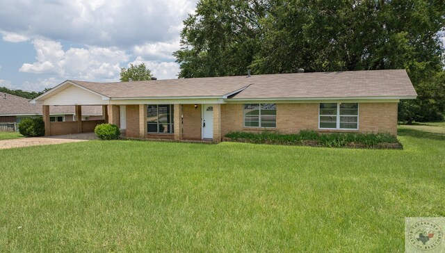 ranch-style home featuring a front yard and a carport