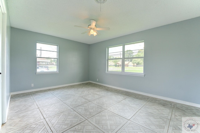 spare room with ceiling fan and a textured ceiling