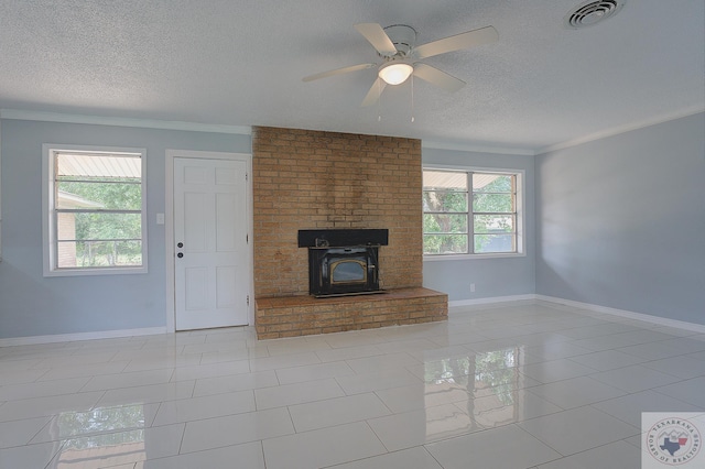 unfurnished living room featuring ceiling fan, ornamental molding, light tile patterned floors, and a textured ceiling