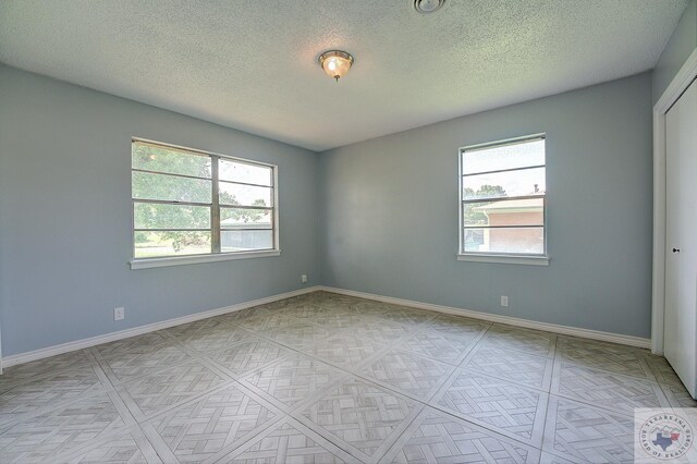 empty room featuring a textured ceiling