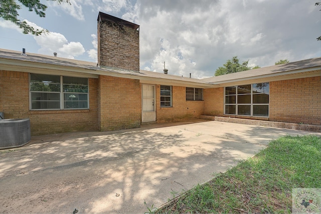 back of house with a patio area and central AC