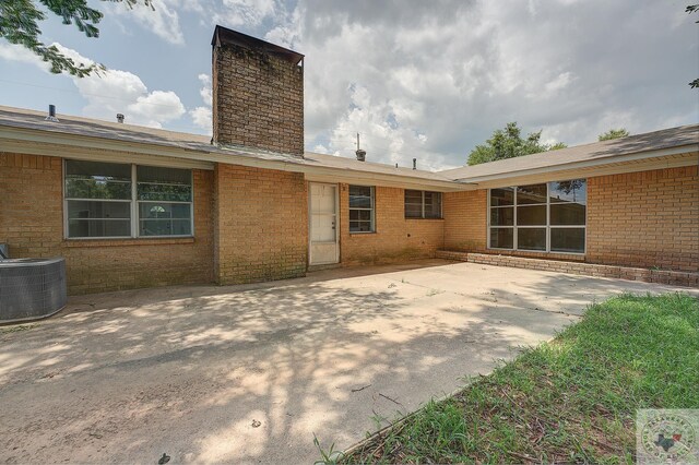 back of house with a patio area and central AC