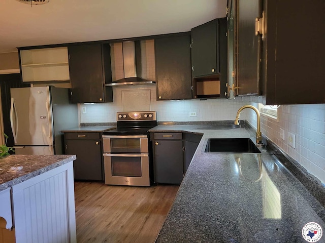 5105 Tennessee Rd, Texarkana, AR 71854 - kitchen featuring stainless steel appliances, wall chimney range hood, backsplash, light wood-style flooring, and open shelves